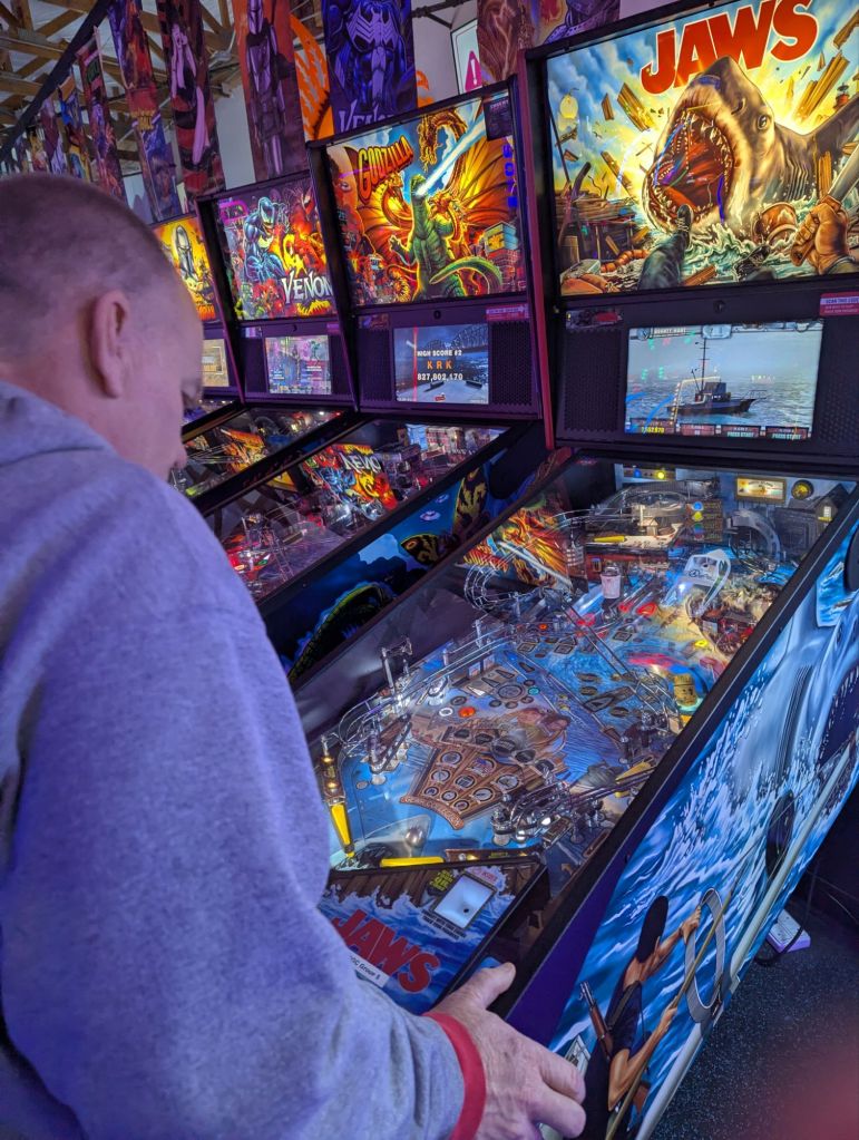 Man playing Jaws pinball game